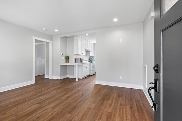 unfurnished living room with recessed lighting, visible vents, baseboards, and dark wood-style floors