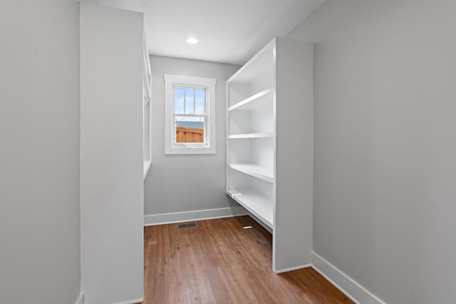 walk in closet featuring visible vents and wood finished floors