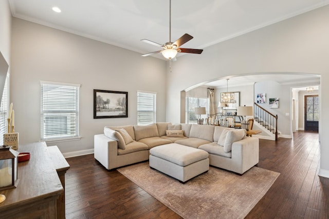 living room with arched walkways, dark wood-style floors, and baseboards