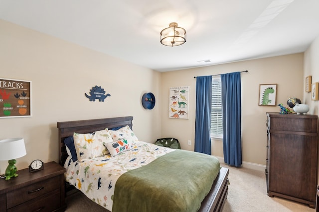 bedroom with baseboards and light colored carpet