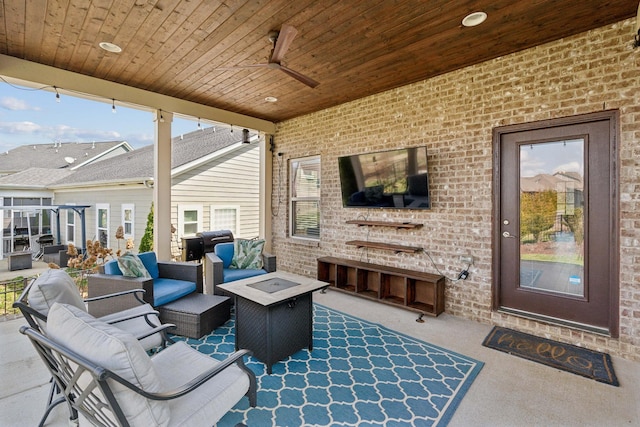 view of patio / terrace with an outdoor living space with a fire pit, a ceiling fan, and a grill