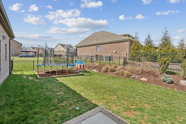 view of yard featuring a trampoline and a fenced backyard