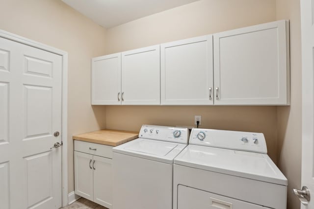 laundry room featuring cabinet space and separate washer and dryer