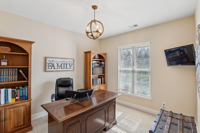 office with visible vents, light colored carpet, and baseboards