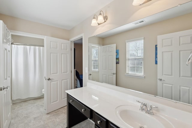 bathroom featuring visible vents, a shower with curtain, vanity, and toilet