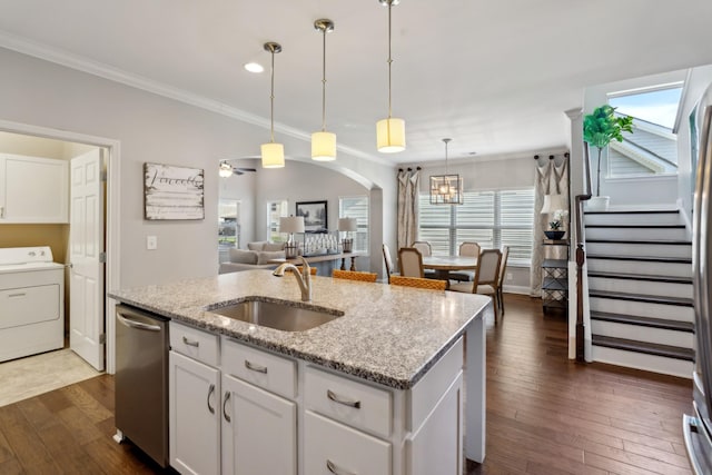 kitchen featuring a sink, washer / dryer, dark wood-style flooring, and dishwasher