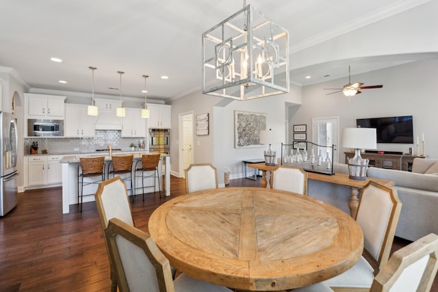 dining space with recessed lighting, dark wood-style floors, crown molding, and ceiling fan with notable chandelier