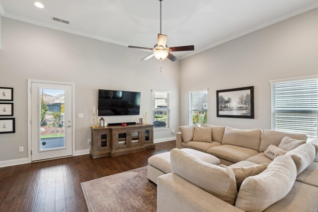 living room with visible vents, ceiling fan, baseboards, and hardwood / wood-style flooring