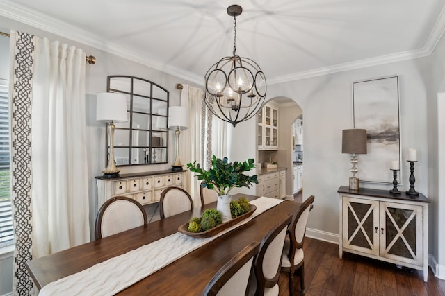 dining room with baseboards, dark wood finished floors, an inviting chandelier, arched walkways, and ornamental molding