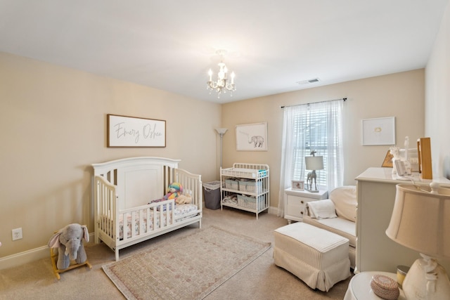 bedroom featuring visible vents, a notable chandelier, carpet floors, a nursery area, and baseboards