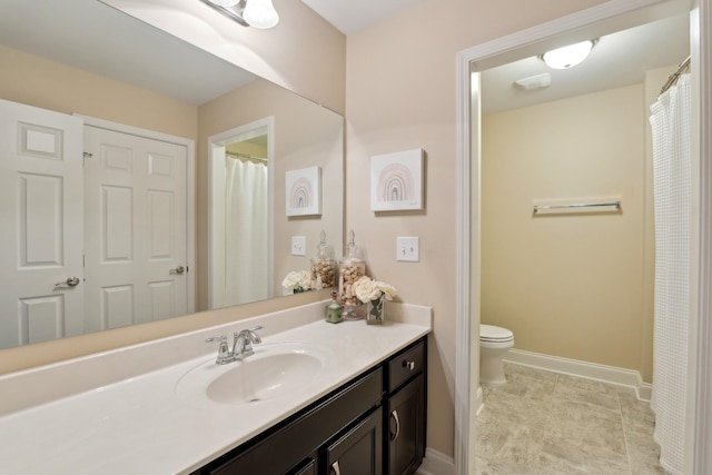 full bathroom with vanity, tile patterned floors, toilet, and baseboards