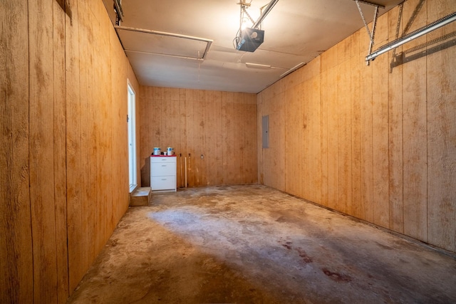 interior space featuring electric panel, a garage, and attic access