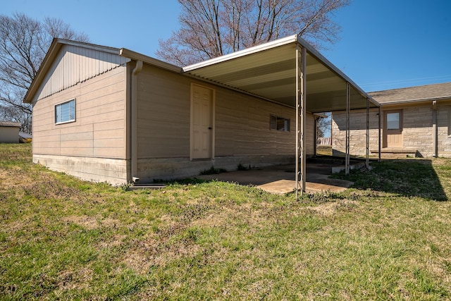 exterior space featuring a carport and a yard