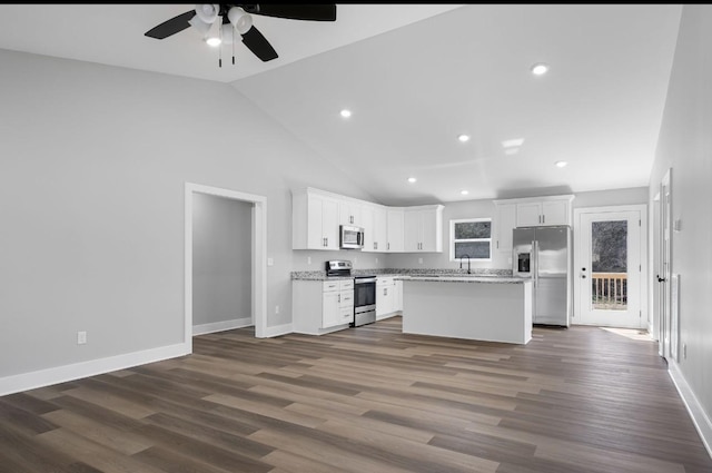 kitchen featuring white cabinets, dark wood-style floors, appliances with stainless steel finishes, and a kitchen island