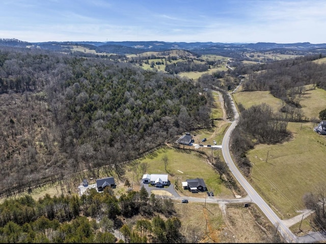 birds eye view of property featuring a rural view and a forest view