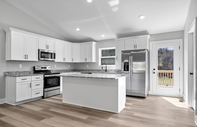 kitchen featuring white cabinets, appliances with stainless steel finishes, and a center island