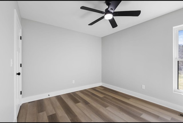 unfurnished room with a ceiling fan, baseboards, and wood finished floors