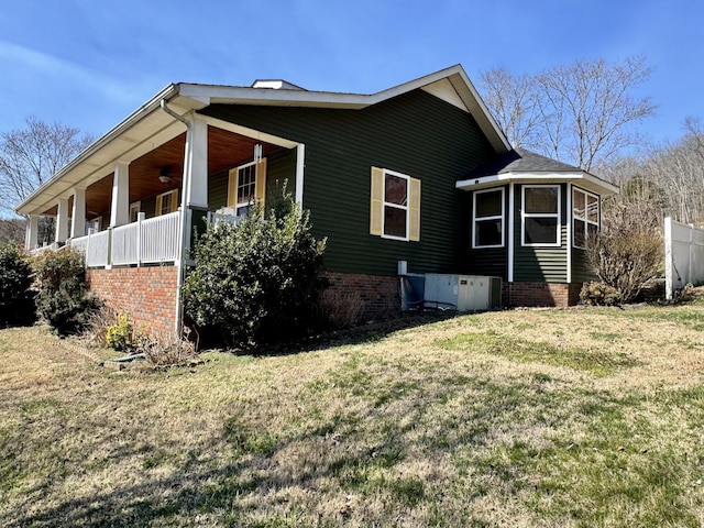 view of home's exterior with a porch and a yard