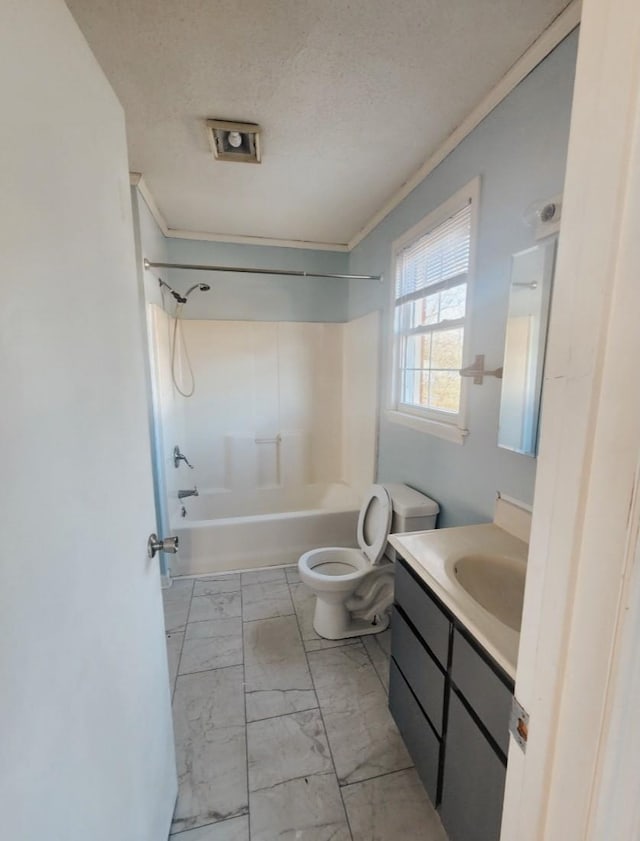 bathroom featuring toilet, marble finish floor, a textured ceiling, shower / washtub combination, and vanity