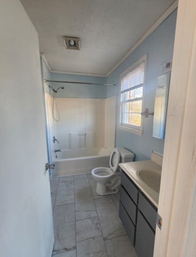 bathroom with toilet, marble finish floor, shower / tub combination, a textured ceiling, and vanity