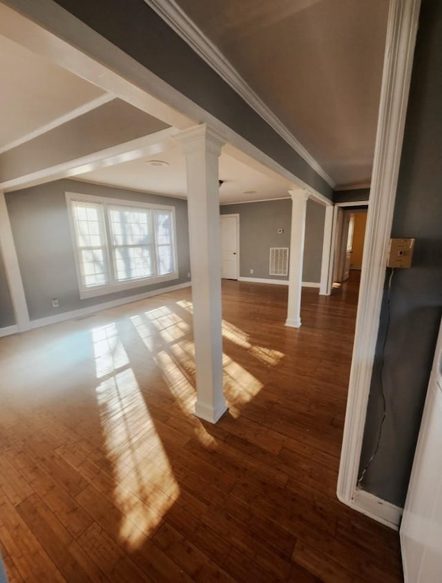 basement with baseboards, wood-type flooring, and crown molding