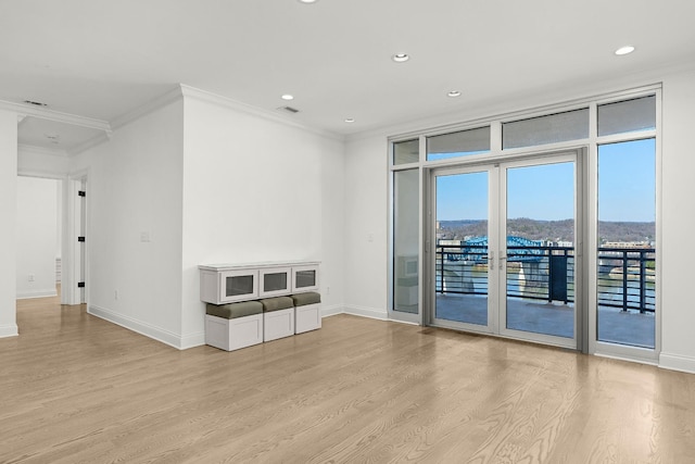 spare room with recessed lighting, baseboards, ornamental molding, and light wood finished floors