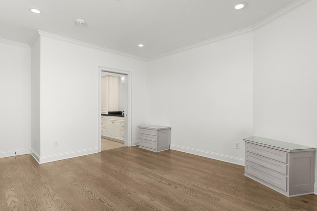 unfurnished bedroom with recessed lighting, baseboards, wood finished floors, and crown molding