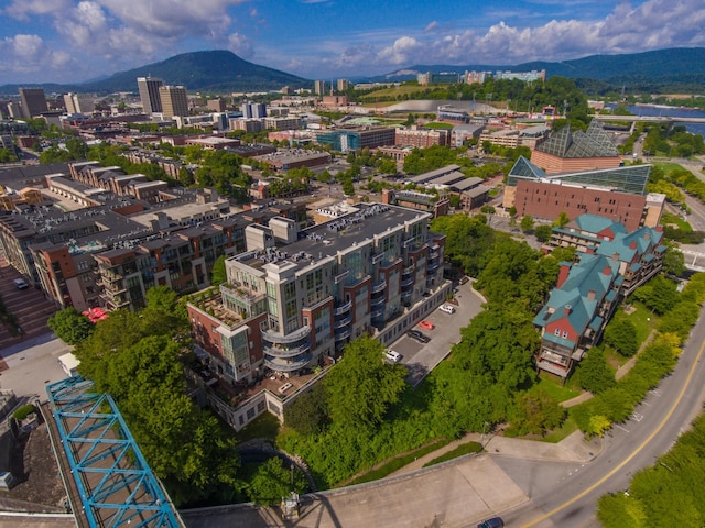 drone / aerial view featuring a mountain view and a city view