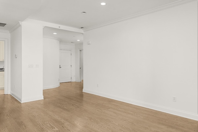 spare room featuring recessed lighting, light wood-type flooring, baseboards, and ornamental molding