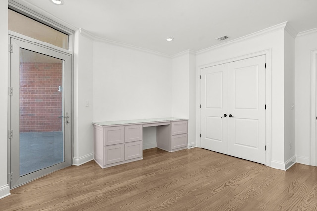 unfurnished bedroom featuring visible vents, built in study area, light wood-style flooring, crown molding, and access to outside