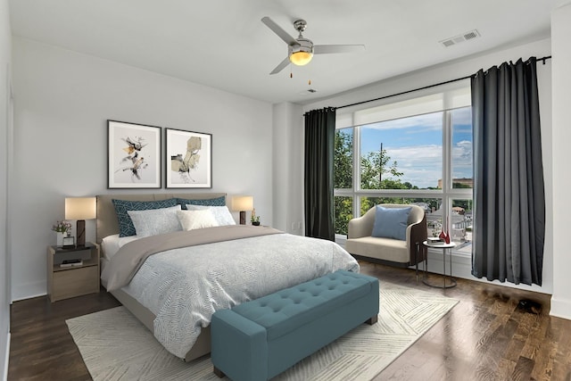 bedroom featuring visible vents, baseboards, wood finished floors, and a ceiling fan