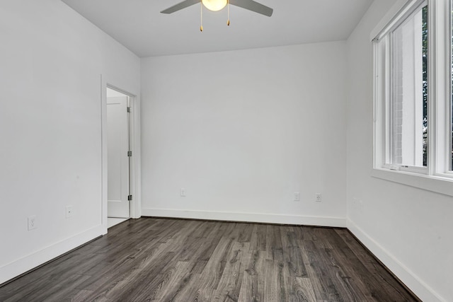 unfurnished room featuring dark wood finished floors, ceiling fan, and baseboards