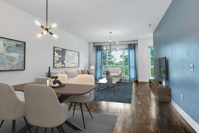 dining area featuring baseboards, a notable chandelier, and wood finished floors