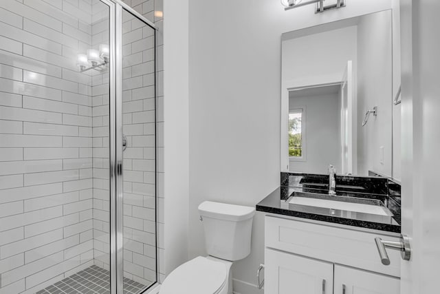 full bath with vanity, toilet, and a shower stall