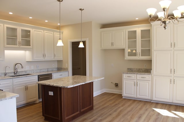 kitchen featuring dishwasher, light wood-style flooring, and white cabinetry