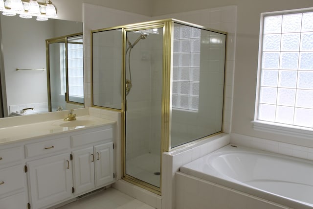 full bathroom with a bath, a shower stall, and vanity