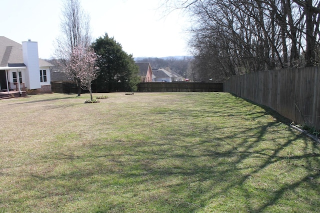 view of yard with a fenced backyard