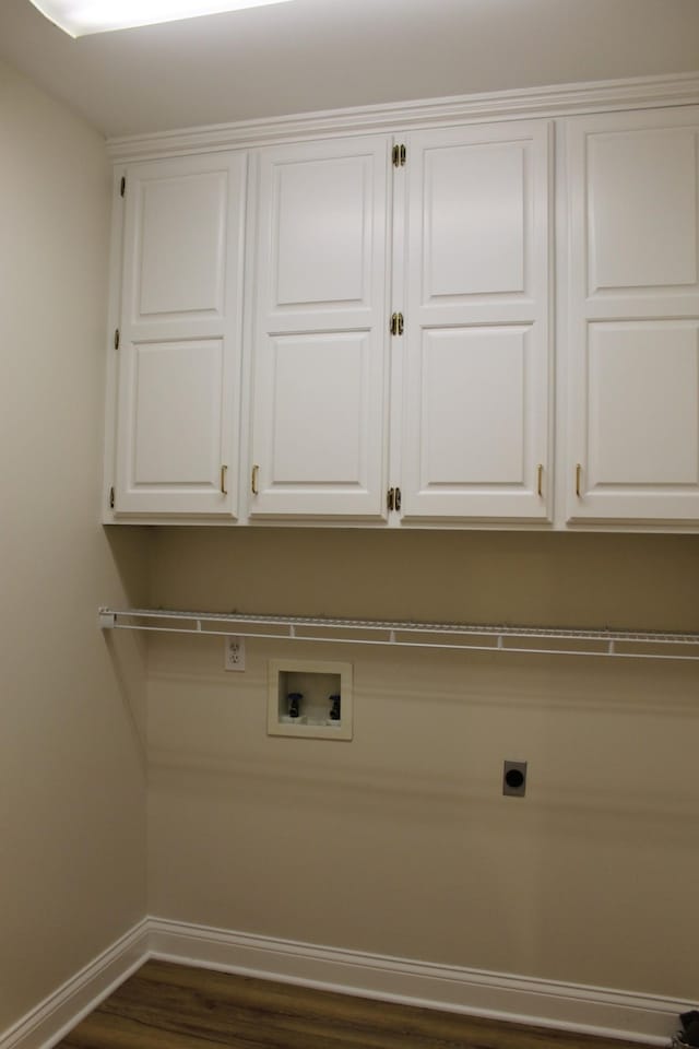 washroom featuring baseboards, hookup for a washing machine, dark wood-style floors, cabinet space, and hookup for an electric dryer