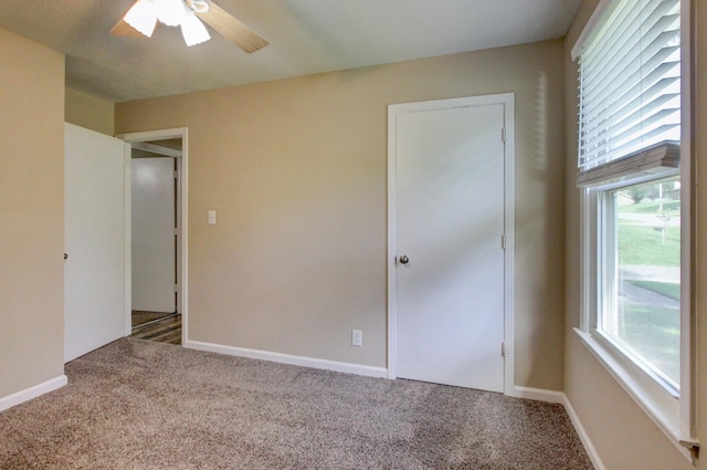 unfurnished bedroom featuring baseboards, ceiling fan, and carpet flooring