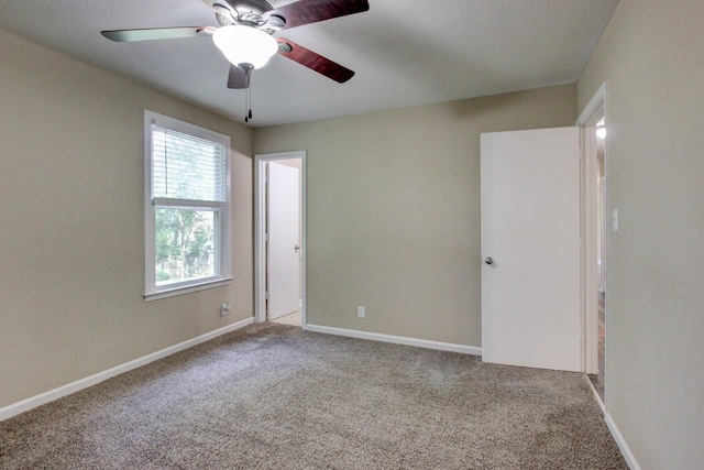 unfurnished bedroom with carpet flooring, ceiling fan, and baseboards