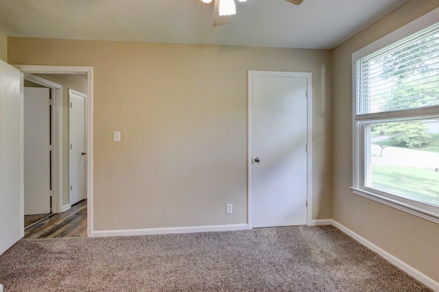 empty room with baseboards, plenty of natural light, and carpet flooring