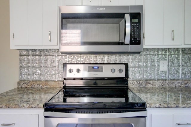 kitchen featuring white cabinets, backsplash, light stone countertops, and appliances with stainless steel finishes