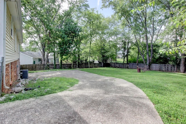 view of yard featuring cooling unit, a patio area, and a fenced backyard