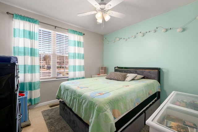 bedroom with ceiling fan, baseboards, visible vents, and light carpet