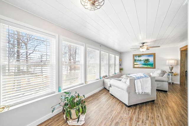 living area with wooden ceiling, baseboards, wood finished floors, and a ceiling fan