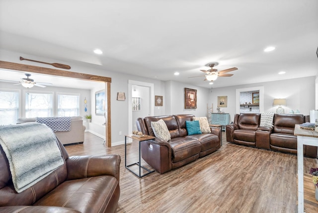 living area with recessed lighting, wood finished floors, baseboards, and ceiling fan