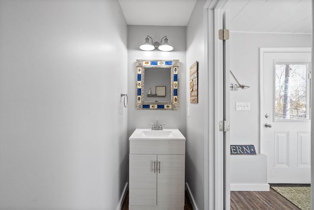 bathroom with vanity, baseboards, and wood finished floors