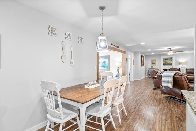 dining space featuring recessed lighting, a ceiling fan, baseboards, and wood finished floors