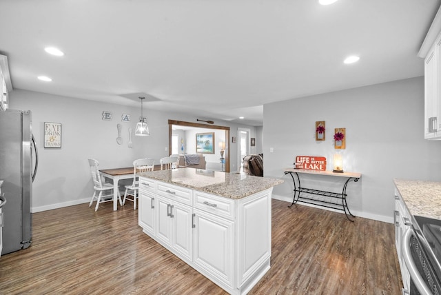 kitchen featuring dark wood finished floors, white cabinets, baseboards, and appliances with stainless steel finishes