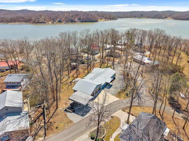 bird's eye view featuring a wooded view and a water view